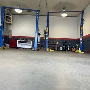 Auto repair service bays with vehicle lifts inside the Wappingers Falls automotive shop